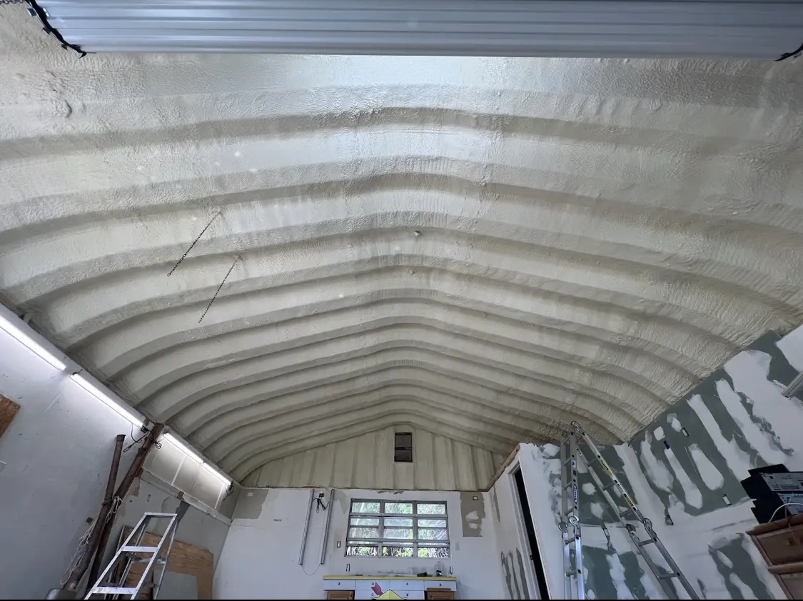 Spray polyurethane foam applied to the underside of a metal roof deck in Dexter